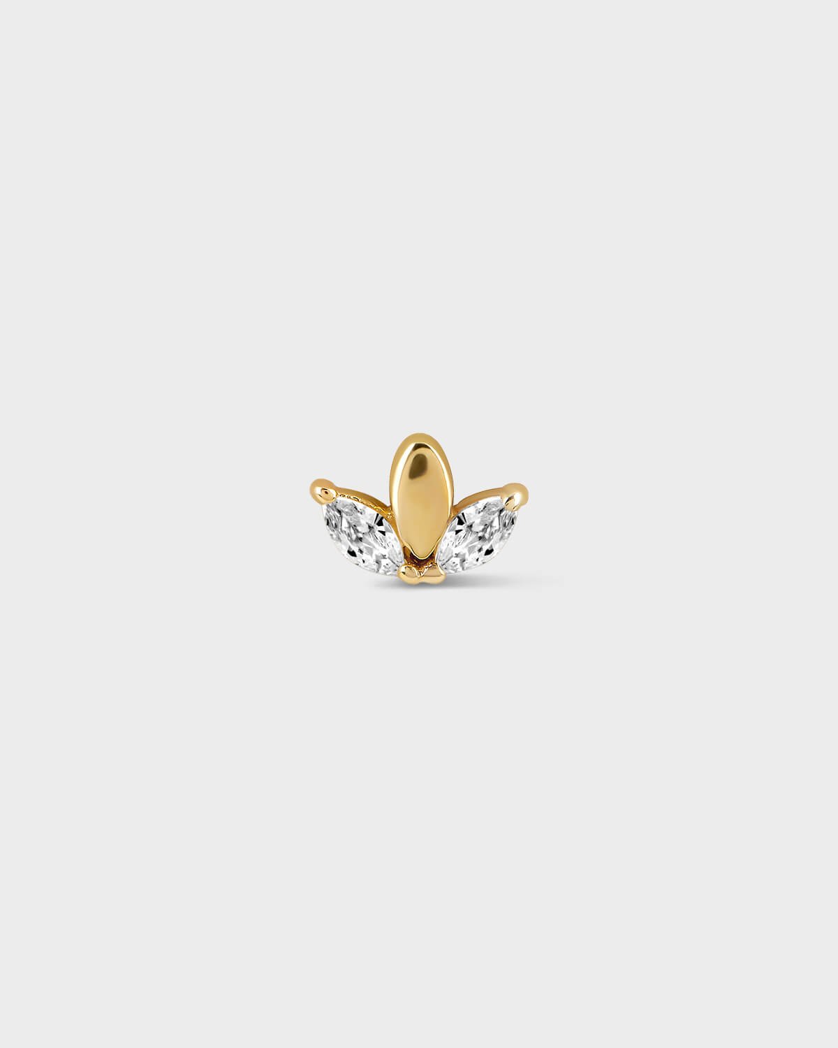 Gold and clear gemstone earring on a light gray background
