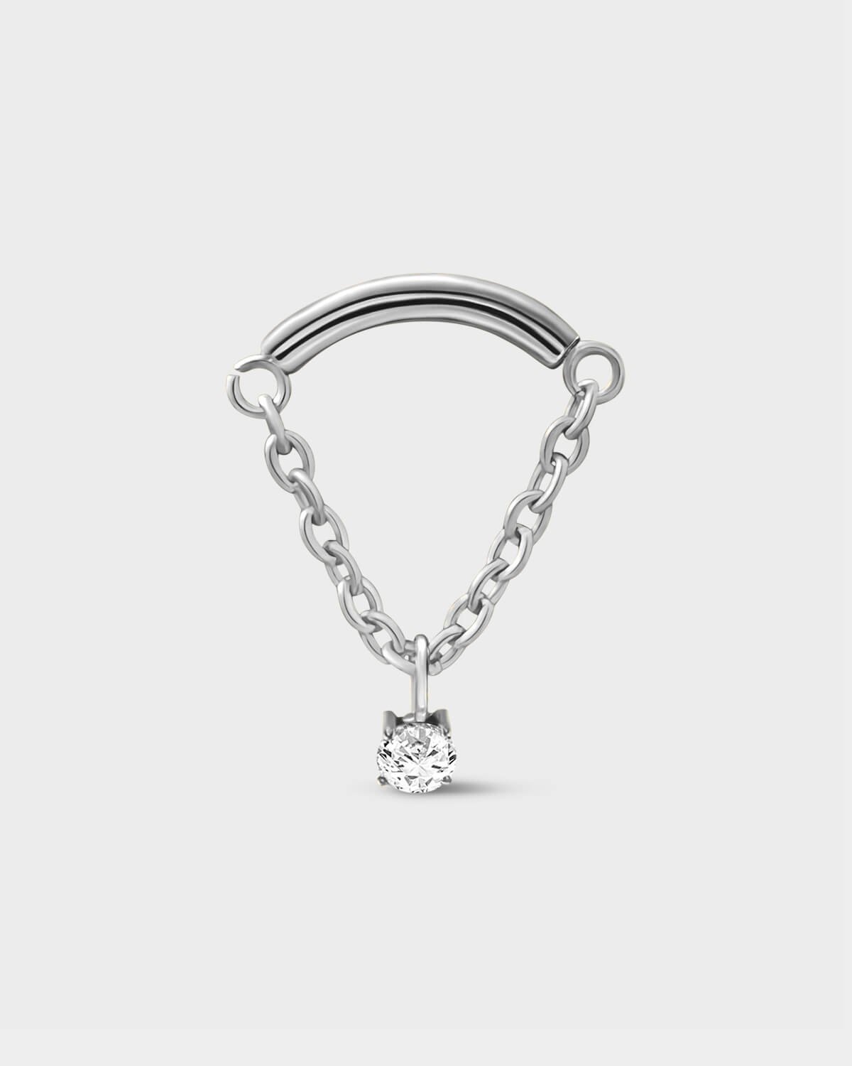 Polished silver titanium earring used for hidden helix or hidden rook featuring a smooth curved bar with a chain connected at each end and a single clear solitaire pendent on a light grey background.