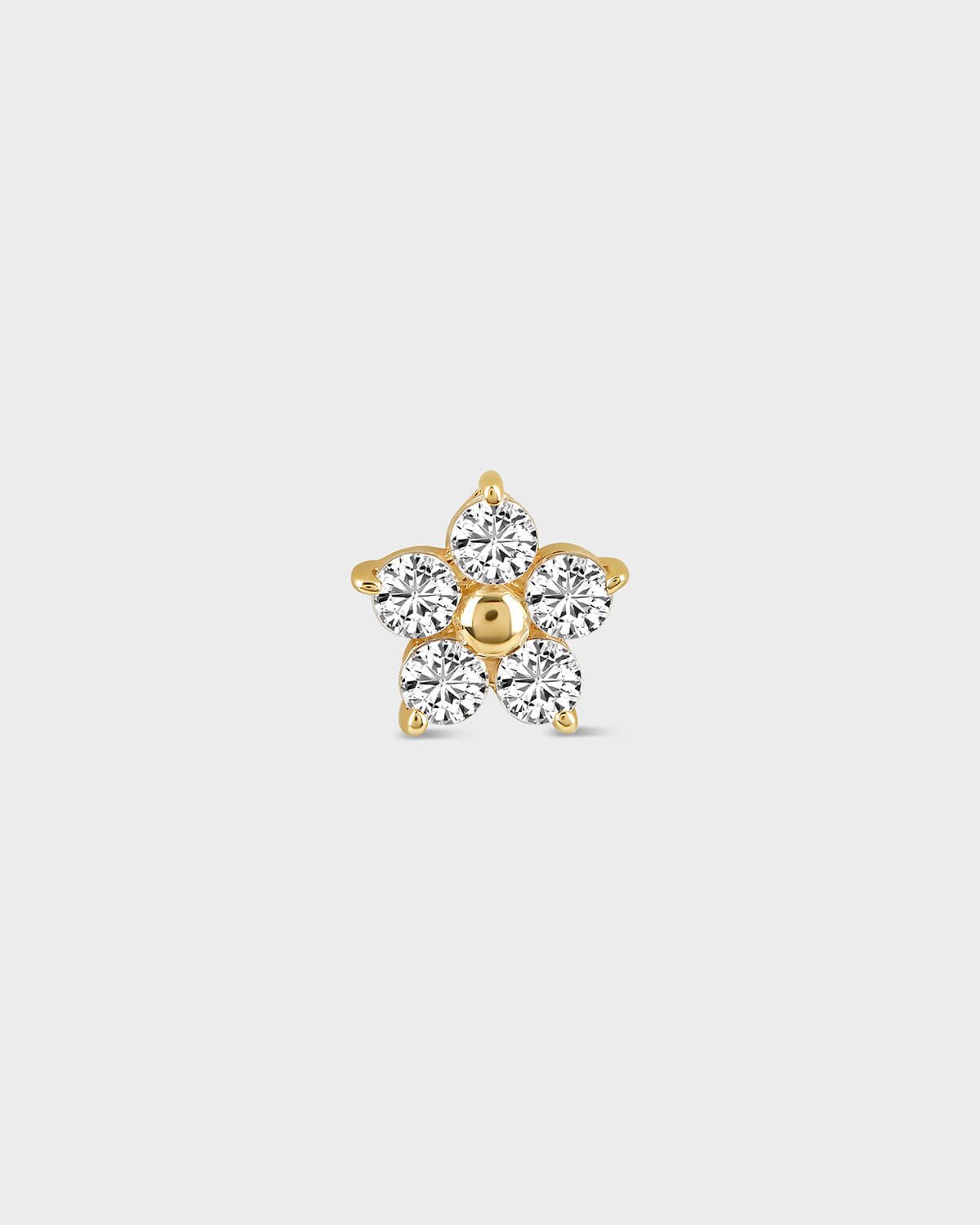 Flower shaped diamond earring on a light gray background