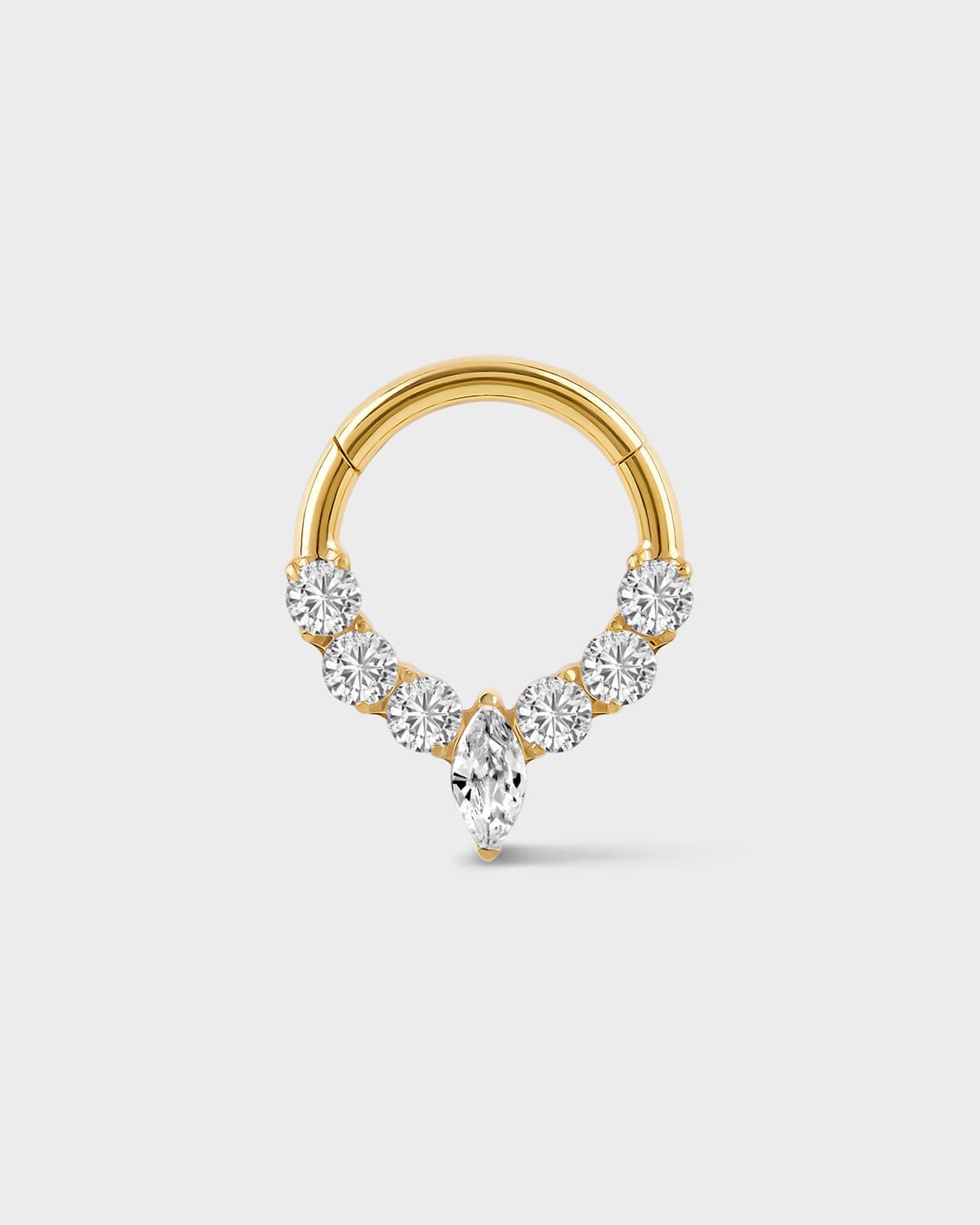 Gold daith ring with central marquise gemstone and three gem either side on a light gray background