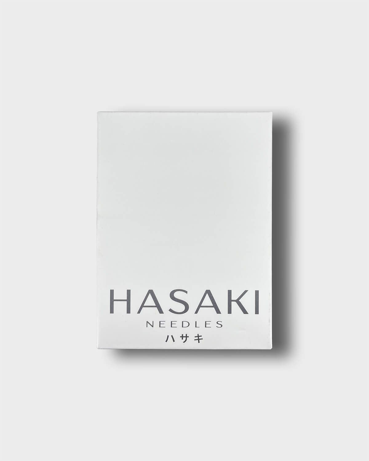 Out box of hasaki piercing needles on a light grey background