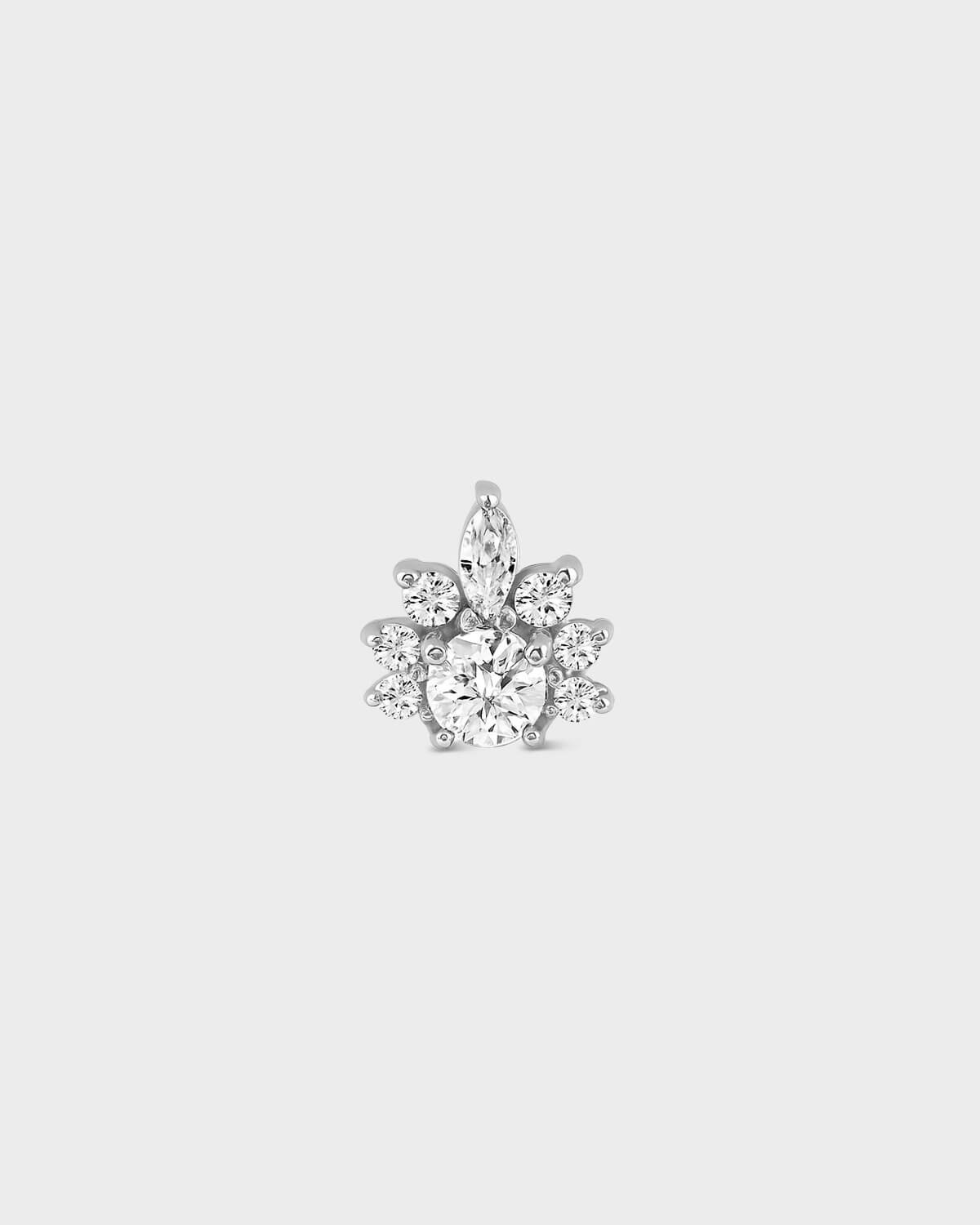 Silver earring with clear gemstones on a white background